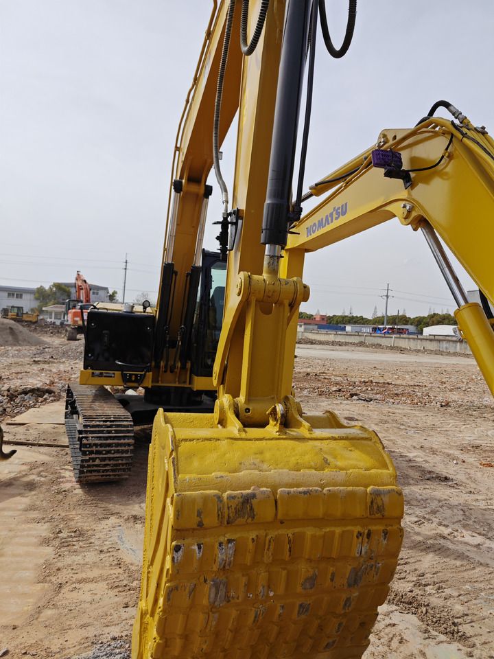 Komatsu excavator, close-up view of bucket and arm Komatsu excavator, close-up view of bucket and arm