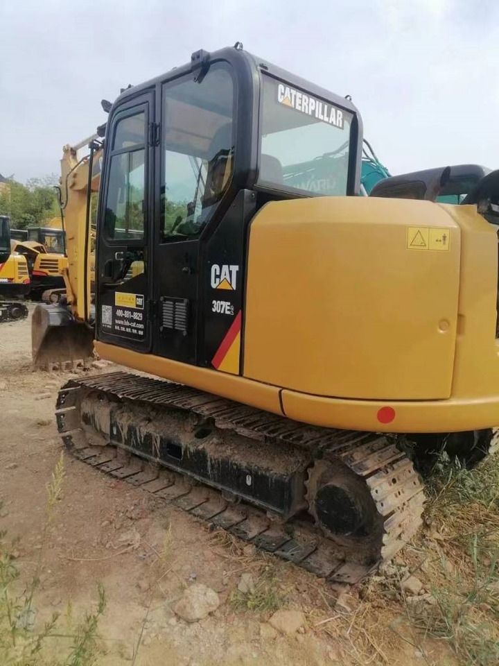 2023 Caterpillar 307E2 mini excavator, rear three-quarter view 2023 Caterpillar 307E2 mini excavator, rear three-quarter view