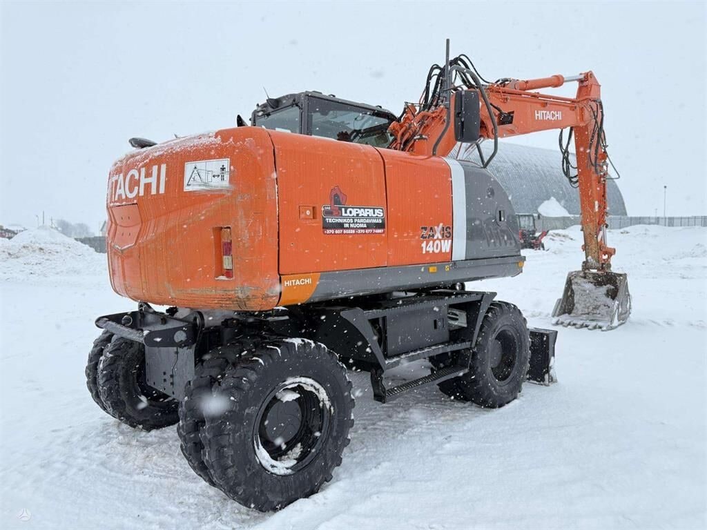 2010 Hitachi Zaxis 140W wheel excavator, rear three-quarter view 2010 Hitachi Zaxis 140W wheel excavator, rear three-quarter view