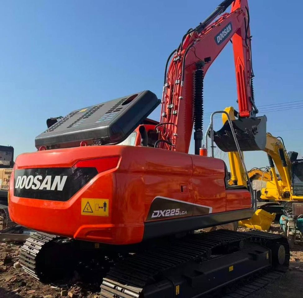 2024 Doosan DX225LCA mini excavator, rear three-quarter view