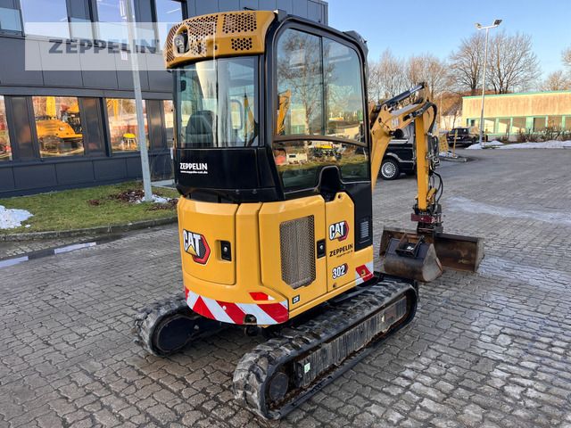2022 Caterpillar 302-05A mini excavator, rear three-quarter view