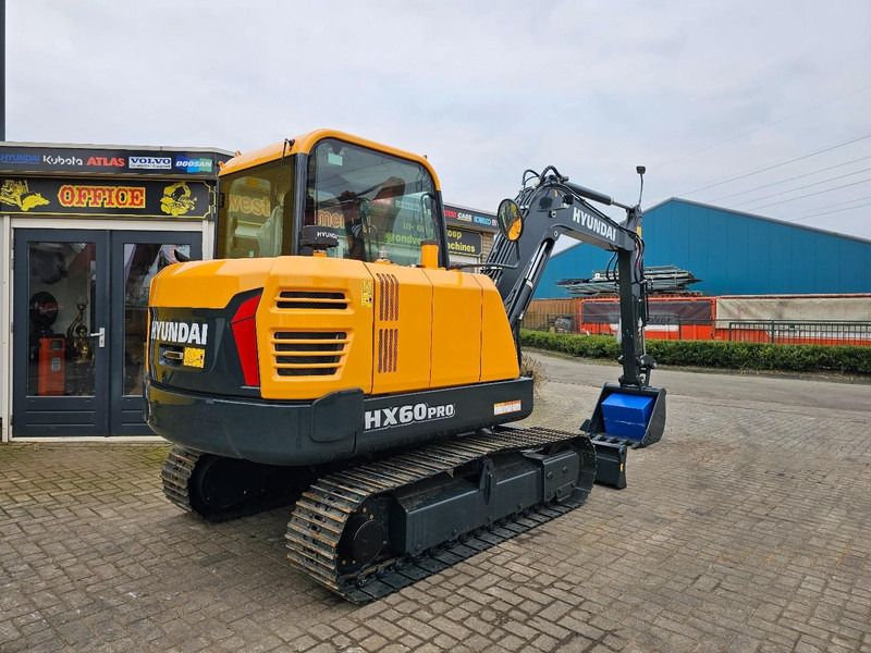 2025 Hyundai HX60PRO mini excavator, rear three-quarter view 2025 Hyundai HX60PRO mini excavator, rear three-quarter view