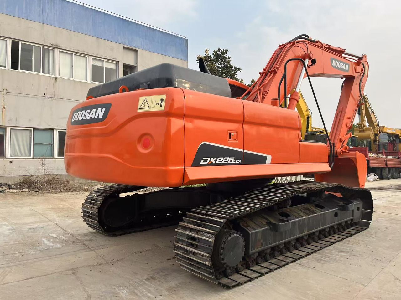 2023 Doosan DX225LCA crawler excavator, rear three-quarter view 2023 Doosan DX225LCA crawler excavator, rear three-quarter view