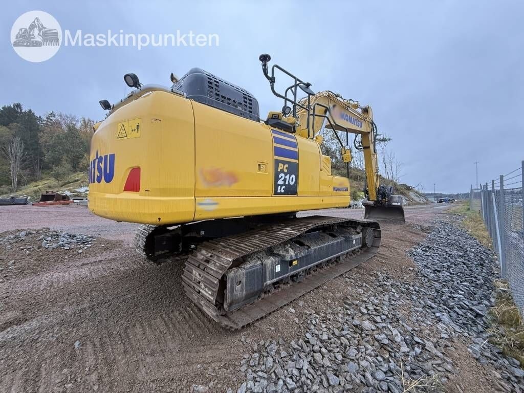 2022 Komatsu PC210LC-11 crawler excavator, rear three-quarter view 2022 Komatsu PC210LC-11 crawler excavator, rear three-quarter view
