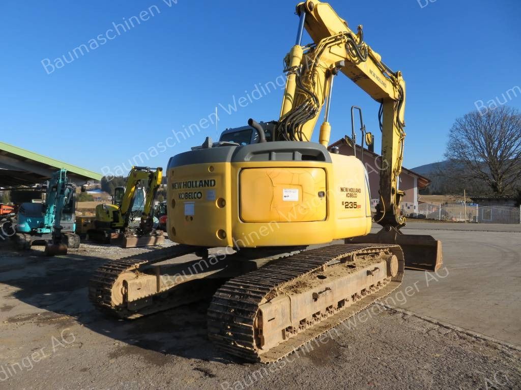 2009 New Holland E235BSR-2 ES crawler excavator, rear three-quarter view 2009 New Holland E235BSR-2 ES crawler excavator, rear three-quarter view