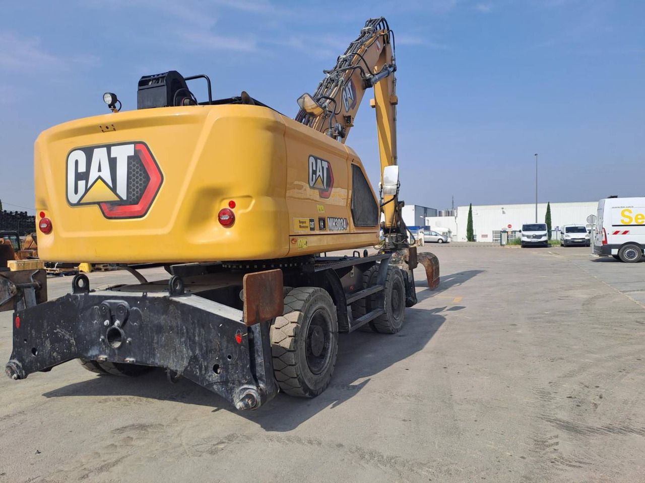 2024 Caterpillar MH3024 wheel excavator, rear three-quarter view