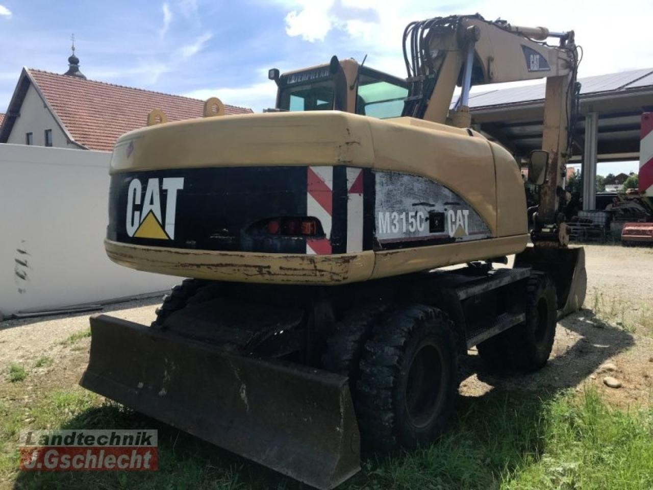 2003 Caterpillar M315C wheel excavator, rear three-quarter view 2003 Caterpillar M315C wheel excavator, rear three-quarter view