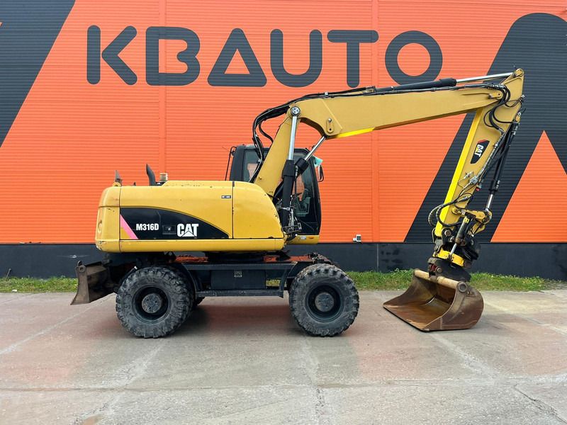 2011 Caterpillar M316D wheel excavator side view 2011 Caterpillar M316D wheel excavator side view