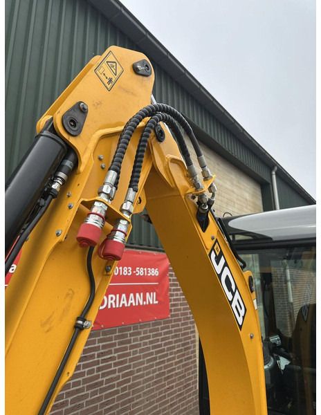 2023 JCB 19C-1 mini excavator boom and hydraulic lines close-up