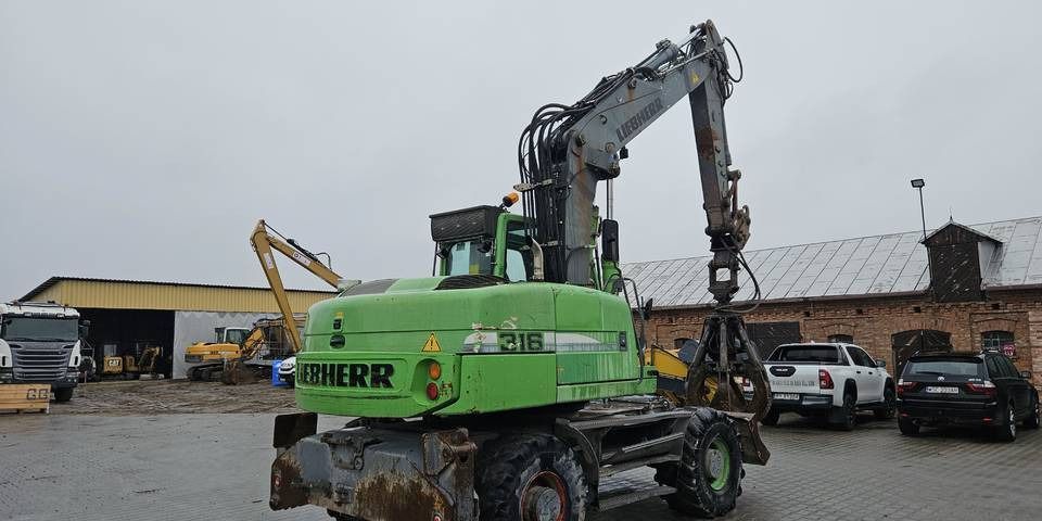 2011 Liebherr A316 LITRONIC wheel excavator, rear three-quarter view