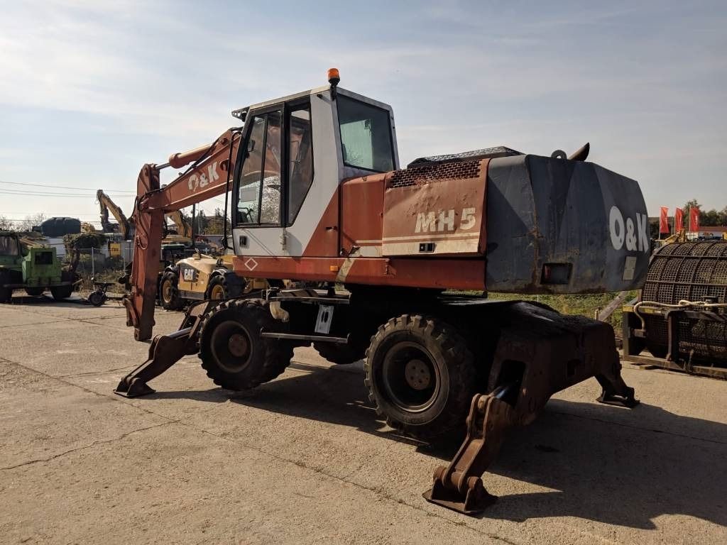 1999 O&K MH 5 wheel excavator, rear three-quarter view 1999 O&K MH 5 wheel excavator, rear three-quarter view