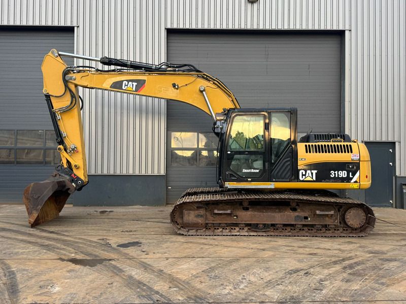 2011 Caterpillar 319DL crawler excavator, side view
