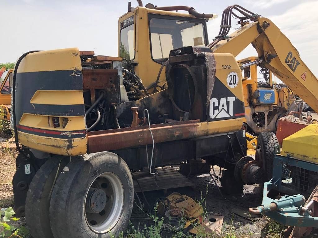 1999 Caterpillar M312 wheel excavator rear three-quarter view 1999 Caterpillar M312 wheel excavator rear three-quarter view