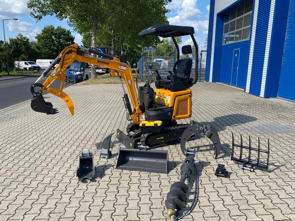 Berger Kraus BK1300JSR mini excavator with attachments, side view