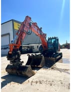 2019 Hitachi ZX135US-6 crawler excavator, front three-quarter view 2019 Hitachi ZX135US-6 crawler excavator, front three-quarter view