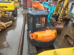 2019 Hitachi ZX55UR mini excavator, rear three-quarter view 2019 Hitachi ZX55UR mini excavator, rear three-quarter view