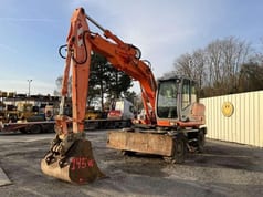 2004 Kobelco E145W wheel excavator, front three-quarter view