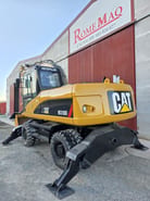 2007 Caterpillar M318D wheel excavator rear three-quarter view