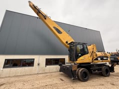 2008 Caterpillar M325D material handler, side view