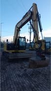 2021 Caterpillar 310-07 crawler excavator, front three-quarter view