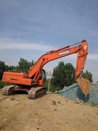 2022 Doosan DX225LC crawler excavator, side profile view
