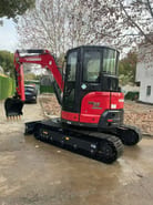 2024 Yanmar VIO55-6B mini excavator, rear three-quarter view
