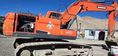 Doosan DX220LC-9 excavator, side view with engine compartment open