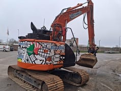 2022 Hitachi ZX135US-6 crawler excavator, rear three-quarter view 2022 Hitachi ZX135US-6 crawler excavator, rear three-quarter view