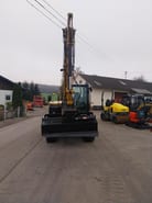 Caterpillar 306CR-07A mini excavator, front view with boom raised