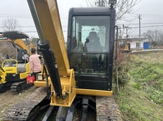 Caterpillar 306 mini excavator, front view of cab and boom Caterpillar 306 mini excavator, front view of cab and boom