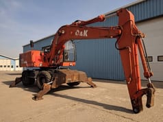 1999 O&K MH 5 wheel excavator, side view