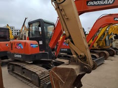 Doosan DH55 mini excavator, front three-quarter view