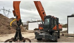 2022 Doosan DX250WMH-7 wheel excavator with grapple attachment, side view