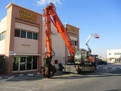 2017 Hitachi ZX360W-3 wheel excavator, side view with grapple attachment