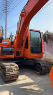 2023 Doosan DX140LC crawler excavator, front three-quarter view