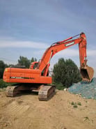2022 Doosan DX225LC crawler excavator, rear three-quarter view 2022 Doosan DX225LC crawler excavator, rear three-quarter view