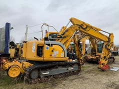2006 New Holland E135SR-1ES crawler excavator, rear three-quarter view