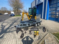 Berger Kraus BK950KS mini excavator on trailer with attachments