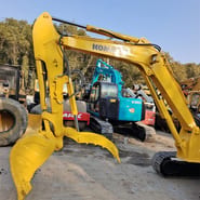 2024 Komatsu PC55 crawler excavator, side view of boom and thumb attachment