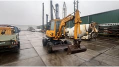 1990 Komatsu PW30-1 wheel excavator, front three-quarter view