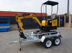 JPC HT-12 mini excavator on a trailer, side view JPC HT-12 mini excavator on a trailer, side view