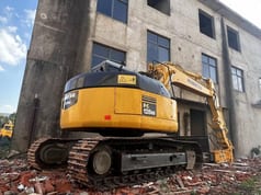 Komatsu PC128US excavator, rear three-quarter view Komatsu PC128US excavator, rear three-quarter view