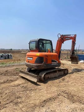 2023 Doosan DX55-9C mini excavator, rear three-quarter view 2023 Doosan DX55-9C mini excavator, rear three-quarter view