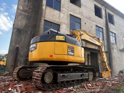 Komatsu PC128US excavator, rear three-quarter view Komatsu PC128US excavator, rear three-quarter view