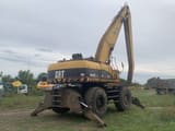 2005 Caterpillar M325C MH material handler, rear three-quarter view