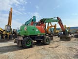 2006 New Holland MH-PLUS wheel excavator, rear three-quarter view
