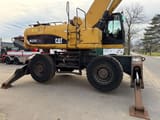 2011 Caterpillar M325D material handler side view