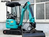 2026 Rippa R322L Mini Excavator with a wide grading bucket attached, positioned in a front three-quarter view.
