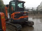 2023 Develon DX50Z-7 mini excavator, rear three-quarter view