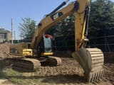 2012 Caterpillar 323DL crawler excavator, side view
